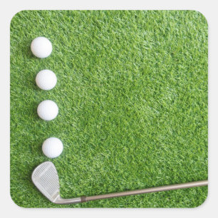 Four golf balls are on green grass with sand wedge square sticker