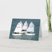 Four Optimist sailing boats