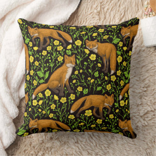 Foxes and buttercups on black cushion