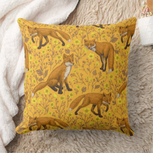 Foxes and buttercups on orange cushion