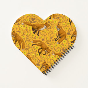 Foxes and buttercups on orange notebook