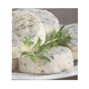 French goat cheese - chevre - with herbs on a notepad