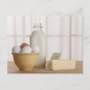 Fresh eggs cheese and milk on counter postcard