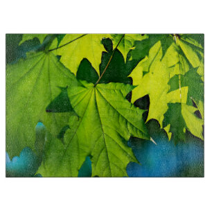 Fresh green maple leaves cutting board