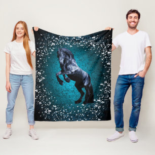 Friesian horse, black stallion, snow, blue fleece blanket