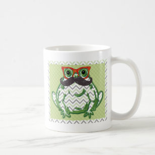 Frog with moustache and fish glasses by coffee mug