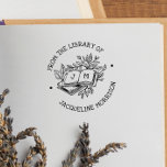 From The Library Of Vintage Botanical Book Initial Rubber Stamp<br><div class="desc">A cute wooden book stamp with rustic lettering, botanical leaves, and tree branches! "From the library of" and your custom name are written in curved text around the central illustration. The text is in whimsical, handwriting-style capital letters. The illustration features a stack of books, the top book is laying open...</div>