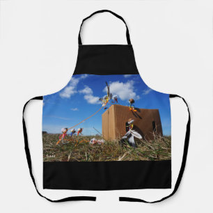 Fubbies playing with feathers and flies. apron