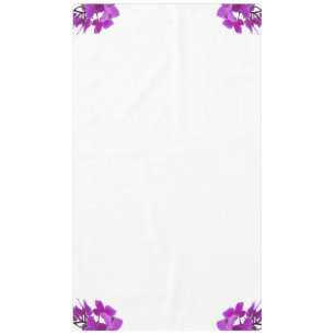Fuchsia orchids decorate corners of a tablecloth