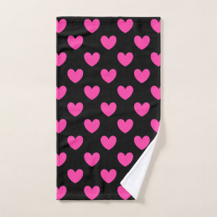 Fuchsia pink polka hearts on black hand towel