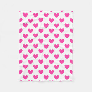 Fuchsia pink polka hearts on white fleece blanket