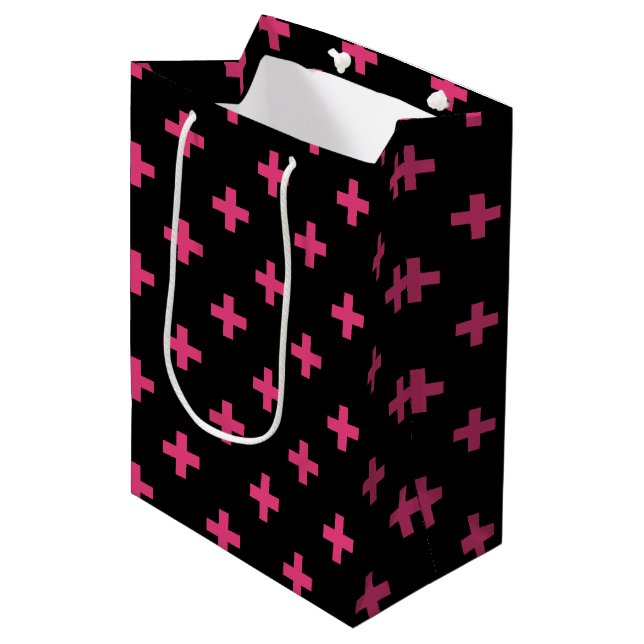 Fuchsia polka crosses on black medium gift bag (Front Angled)