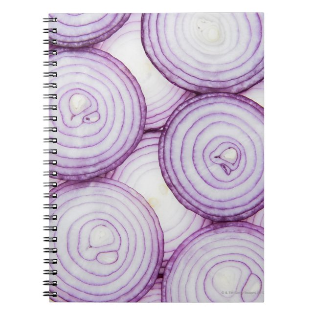 Full frame of sliced red onion, on white notebook (Front)