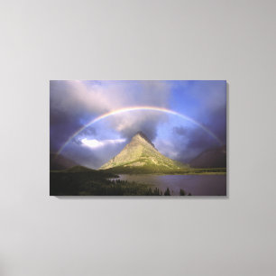 Full rainbow and stormy sky over Grinnell Canvas Print