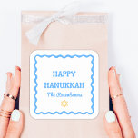 Fun Modern Wavy Border Blue Hanukkah Present Square Sticker<br><div class="desc">Celebrate the holiday season with these Happy Hanukkah stickers, perfect for adding a refined and personalised touch to your festivities. Featuring a festive blue wavy border and customisable family name text, these stickers bring a blend of classic charm and modern style to gift wrapping, party favours, or holiday decor. Ideal...</div>