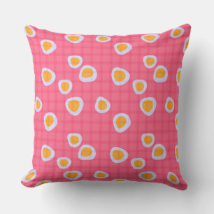 Fun spots on a coral pink checkered background cushion
