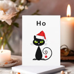 Funny Black Sitting Santa Claus Christmas Cat Postcard<br><div class="desc">Shows a black cat with green eyes and curly tail. The cat wears a red Santa Claus hat and has a Christmas star ornament hanging from its tail. The text above reads "Ho, " which is an unenthusiastic "ho ho ho." Customise and personalise the back text, which reads "Man, it's...</div>