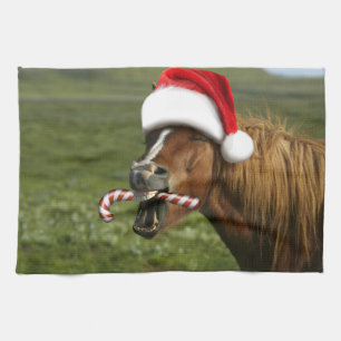 Funny Christmas horse with Santa hat smiling Tea Towel