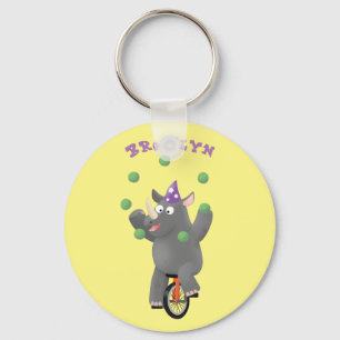 Funny cute rhino juggling on unicycle cartoon key ring