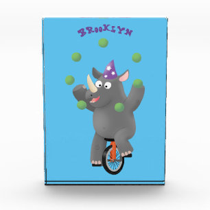 Funny cute rhino juggling on unicycle photo block