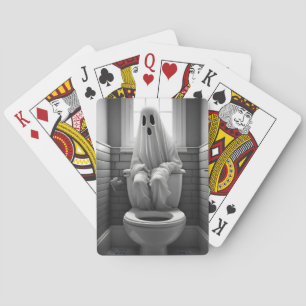 Funny ghost sitting in toilet playing cards