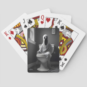 Funny ghost sitting in toilet playing cards