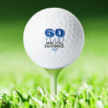 Funny Golf Balls 60th Birthday Party Monogrammed<br><div class="desc">Your golfer who is turning sixty will get a laugh from these personalised Golf Balls. Features a design with text that reads "60 Years And Still Swinging". (You can change the number to any year.) Personalise with monogrammed initials, name or date. A perfect for gift or party favour for a...</div>