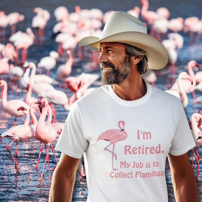Funny Lawn Flamingo Retirement T-Shirt (senior man wearing funny pink flamingo retirement tee with flock of pink flamingos behind him)