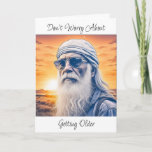 Funny Old Age Humour Birthday Card<br><div class="desc">Funny old hippie or biker dude with long beard and bandanna on his head with the sunset in the background. Birthday aging humour on the card. "Don't worry about getting older,  you're still going to do dumb fun stuff,  just slower."</div>