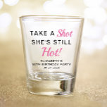 Funny Pink 50th Birthday Party Favour Shot Glass<br><div class="desc">Funny pink and black "Take a Shot She's Still Hot" 50th birthday party favour shot glass. Personalise with her name and the party date.</div>