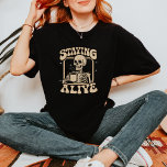 Funny Skeleton Drinking Coffee Staying Alive T-Shirt<br><div class="desc">Quality t-shirt with a Funny Skeleton Drinking Coffee Staying Alive. Great gift for a coffee addict.</div>