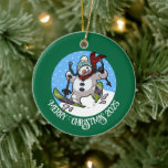 Funny Snowman Merry Christmas Add The Year Cartoon Ceramic Tree Decoration<br><div class="desc">A funny skiing snowman ornament for your Christmas tree. Use "Personalise this template" to tweak the text or year and make a unique customised xmas gift. The tree decoration features a whimsical cartoon of an excited snowman with a carrot nose, dashing downhill through the snow on skis, in woolly winter...</div>