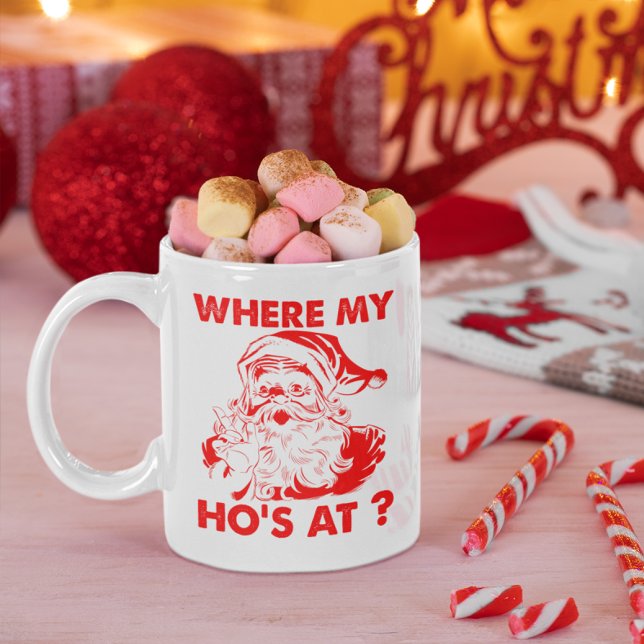 Funny Where My Ho's At Santa Christmas Coffee Mug (Christmas mug with Santa design filled with marshmallows, surrounded by candy canes and festive deco)