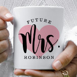 Future Mrs. Pink Heart Monogram Wedding Coffee Mug<br><div class="desc">Personalised coffee mug for the Future Mrs. features modern black script with custom last name text and a pink heart background image.</div>