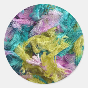 Fuzzy colourful strands of yarn background classic round sticker