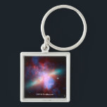 Galaxy M82 Key Ring<br><div class="desc">This image shows a stunning view of a Starburst galaxy produced by space telescopes. M82 is a galaxy about 12 million light years from Earth that is undergoing a burst of star formation. X-rays from Chandra (blue) show gas being blasted away from the galaxy's disc as a bounty of stars...</div>