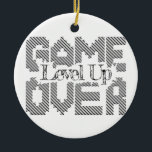 Game Over: Restore Old-School Fun, Level Up Today Ceramic Tree Decoration<br><div class="desc">Game Over is depicted in bold, pixelated lettering, with the words “Level Up” creatively superimposed on it in an ornate script at its centre and a sun shining behind it at the top. The graphic has a retro gaming aesthetic with a playful twist... “This design is customisable. Click the *EDIT...</div>