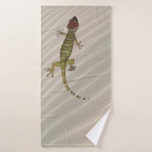 Gecko on sand bath towel