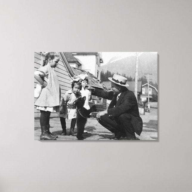 Gentleman and Kids Playing with Bear Cub On Leas Canvas Print (Front)