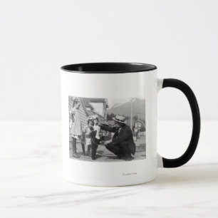 Gentleman and Kids Playing with Bear Cub On Leas Mug