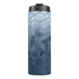 Geometric abstraction of hexagons on a blue relief thermal tumbler