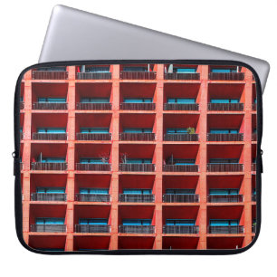 Geometric architectural background of coral colour laptop sleeve