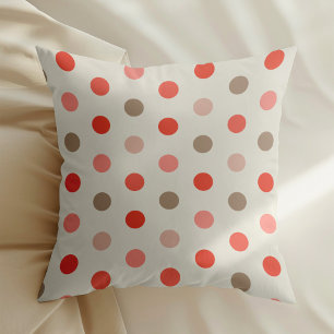 Geometric polka dot pattern in red and pink tones cushion
