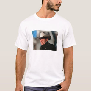 George W. Bush - dressed in black wearing a cowboy T-Shirt