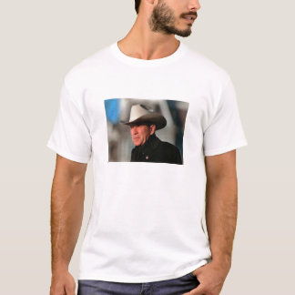 George W. Bush - dressed in black wearing a cowboy T-Shirt