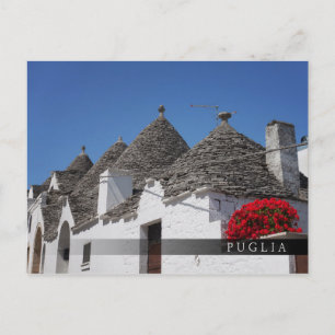 Geranium flowers and trulli houses in Alberobello Postcard