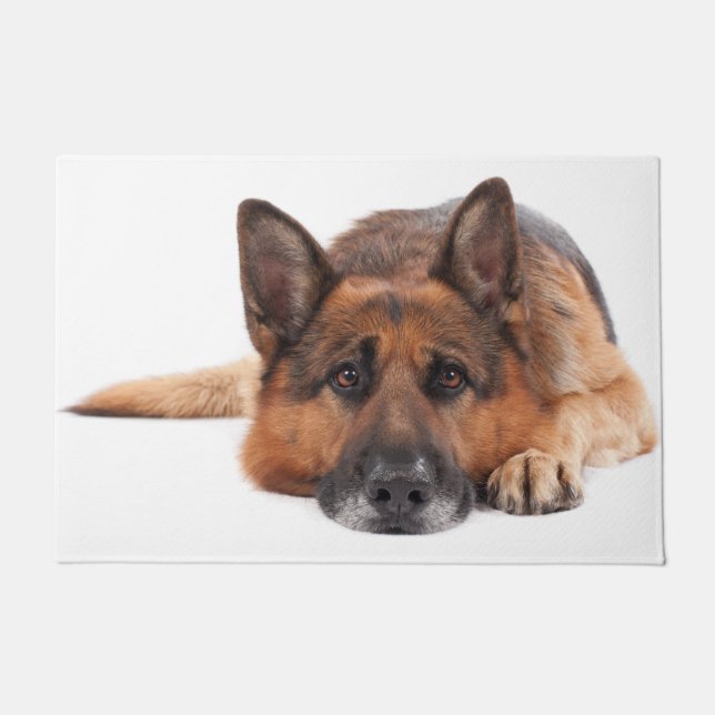 German shepherd lying down on a white background doormat (Front)