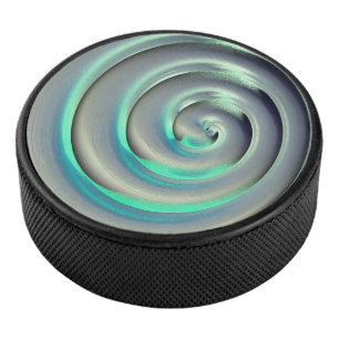 Giant silver and aquamarine spiral over black hockey puck