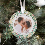 Gilded Greenery White Married and Merry Two Photo Ornament<br><div class="desc">This gorgeous newlyweds holiday keepsake ornament feature a lush, festive wreath of gold leaves, Christmas greenery, and red holly berries on a modern white background. Your personal wedding photo goes in the center along with the words "Married and Merry", and there is even a spot for your name. A second...</div>