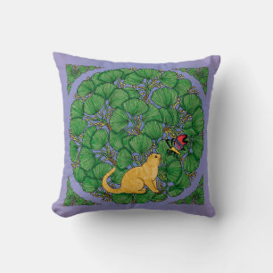 Ginger cat looks at a butterfly cushion